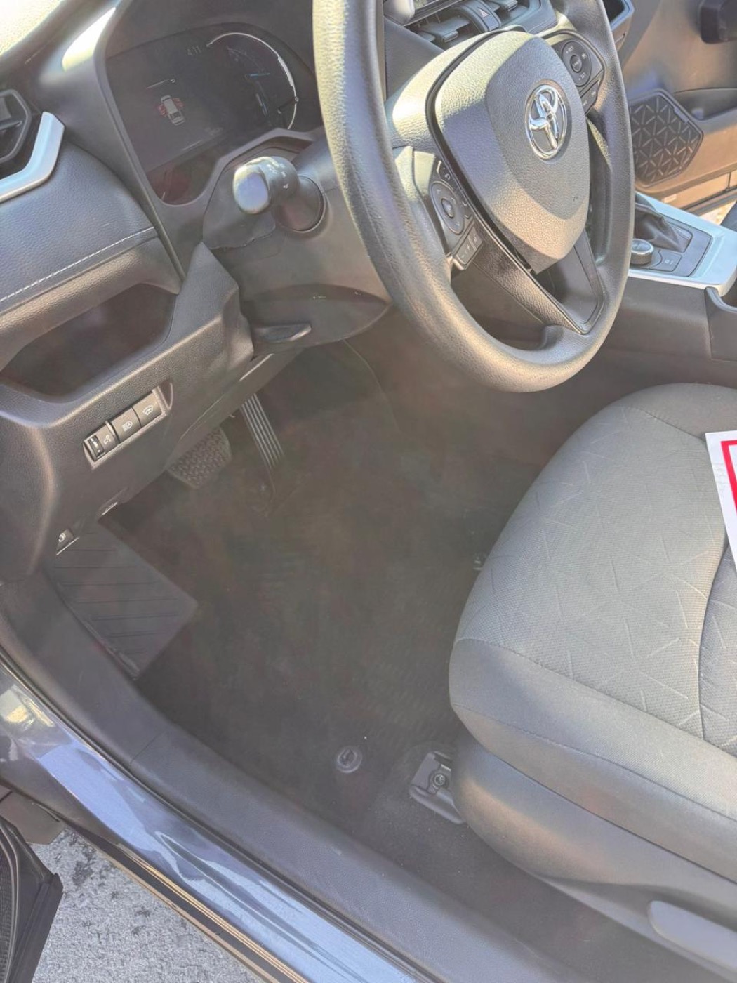 Car floor mat covered in white winter salt stains before, and clean footwell after salt removal — after