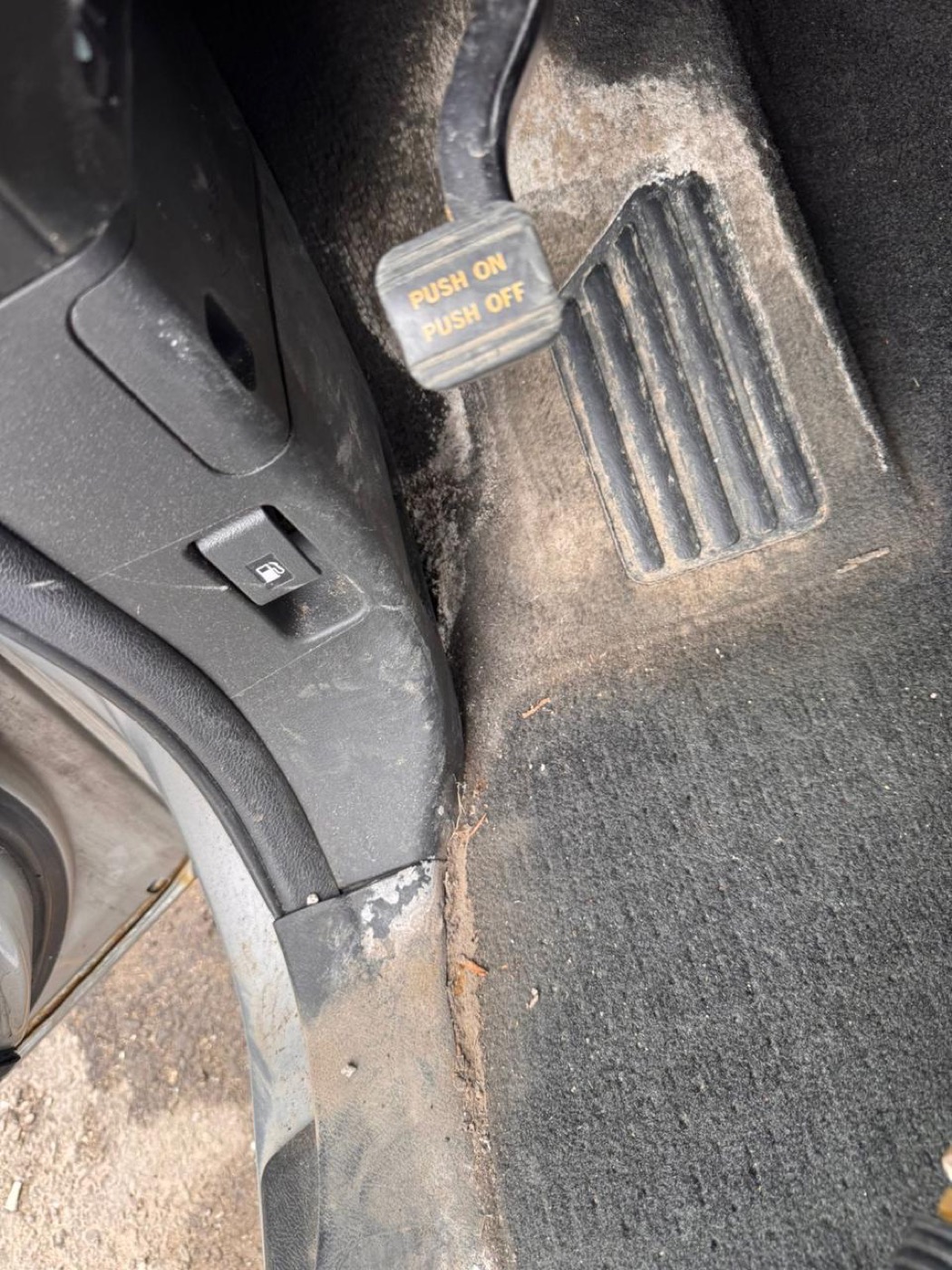 Dusty car pedal and carpet before, and vacuumed clean pedal area after interior detailing — before