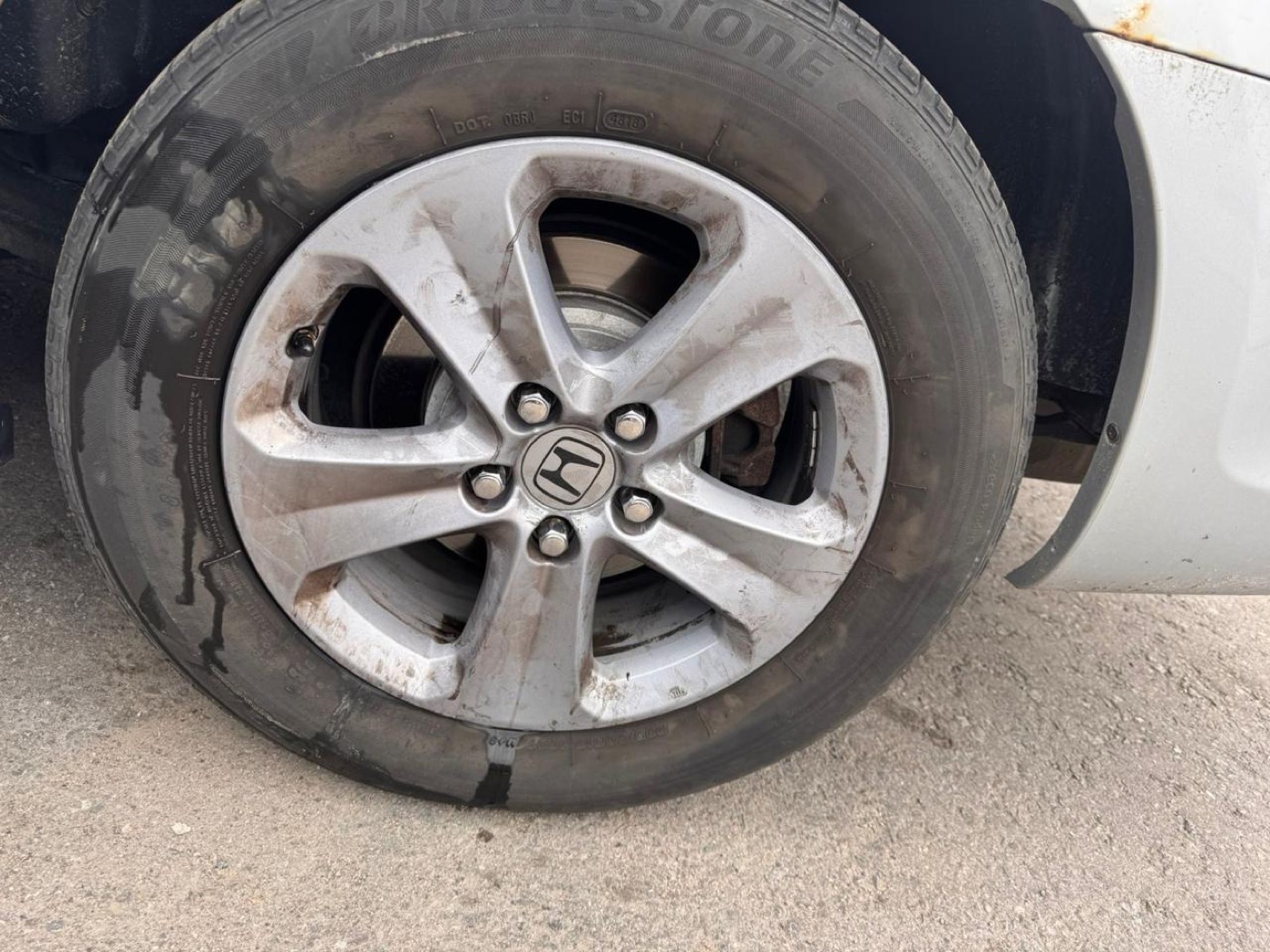 Car wheel covered in brake dust before, and clean and shining after detailing — before