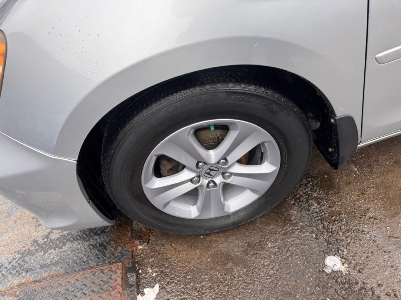 Car wheel covered in brake dust before, and clean and shining after detailing — after